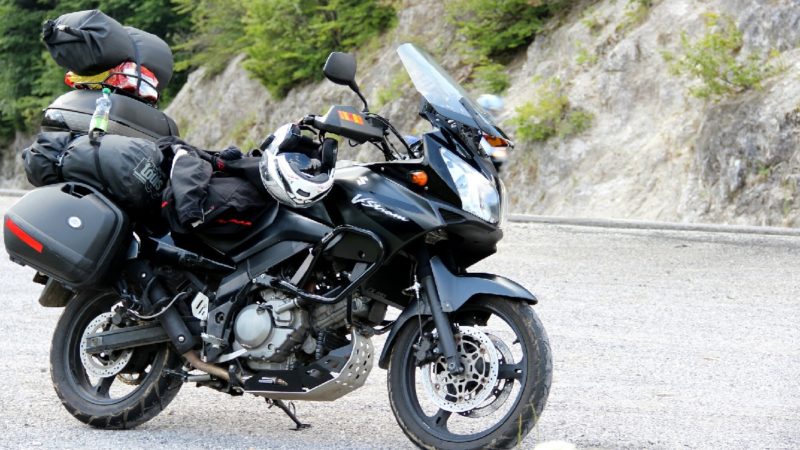 A motorcycle loaded with cargo, illustrating the importance of respecting limits and specifications when preparing materials for transport and printing
